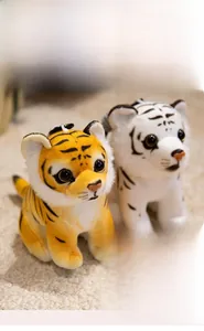 Close-up of soft plush tiger keychain toy with fine texture and hanging string