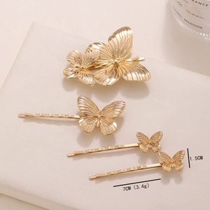 Golden butterfly hair clip set with intricate texture on polished alloy surface