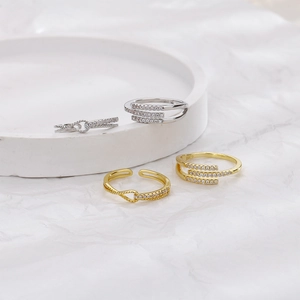 Detail view of gold and silver S925 rings with pave zircon knots and geometric designs