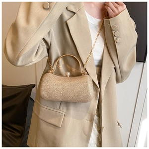 Detail view of champagne gold evening bag with glitter finish and chain strap