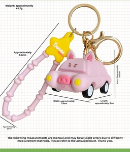 Pink pig cartoon car keychain with silicone wrist strap and yellow star charm detail