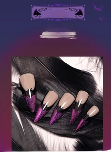 Detail of Halloween stiletto fake nails with black and purple glitter gradient on feathers
