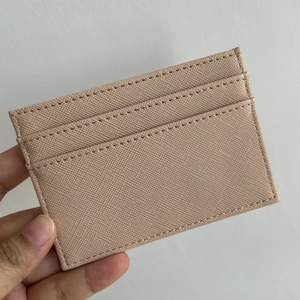 Detail of cross-grain beige PU leather card holder showing multi-slot stitching