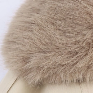 Close-up of soft khaki faux fur collar and twill fabric texture on a short trench coat
