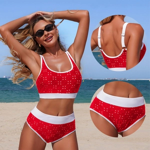 Red high-waisted bikini set with white polka dots featuring sporty wide straps on the beach