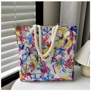 Detail of silver linen tote bag with colorful palm tree prints and thick rope handles