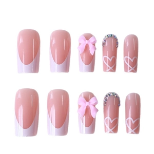 White French tip press-on nails with pink 3D bows and heart patterns on long square nails
