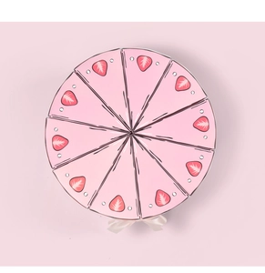 Top view of pink triangle cake-shaped gift boxes arranged in a circle with white ribbons