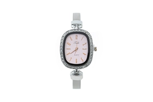 Detailed close-up of a silver mesh strap watch with sparkling rhinestone oval bezel