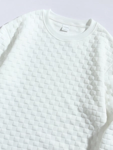 Detailed close-up of white waffle knit sweatshirt neckline showing the size S fabric label