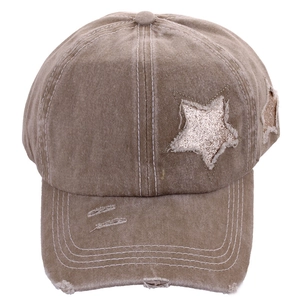 Detail of khaki distressed baseball cap with sparkly star patches and raw edge texture