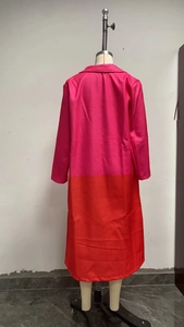 Detail of long sleeve coat with bold color-block design in fuchsia and orange fabric