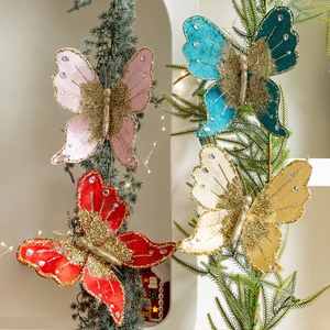 Sparkling butterfly Christmas ornaments with sequins and rhinestones on festive tree branches