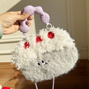 Close-up of cute cartoon plush bag featuring embroidery details and purple handle