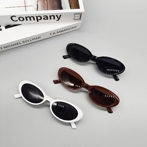 Retro oval sunglasses set in black, brown, and white with stylish narrow frames