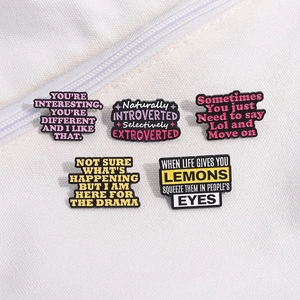 Set of 5 creative enamel pins with humorous English phrases on white canvas background