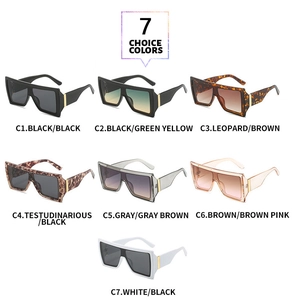 Collection of seven oversized butterfly sunglasses in various colors on white background