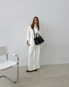 Detailed view of oversized white turtleneck sweater with stylish split cuffs for women