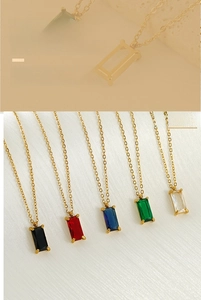 Macro detail of rectangular zircon pendants in multiple colors with 18K gold chain