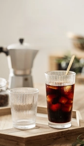 Detailed view of ribbed glass cup featuring vertical texture and golden stirring spoon