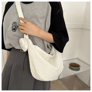 Detail of white puff texture crossbody bag with detachable round coin purse charm