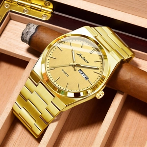 Macro shot of gold quartz watch dial with double calendar display on a cigar box background