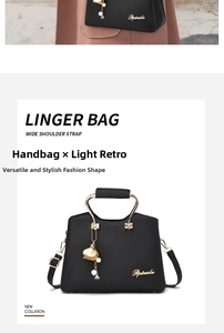 Detail of black lychee leather handbag with golden metal handles and pearl tassel charms