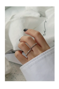 Close-up of minimalist S925 sterling silver beaded geometric ring worn on finger