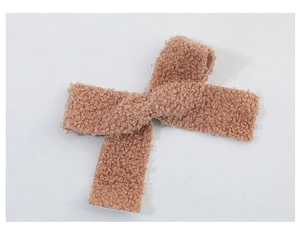 Detail of khaki sherpa fabric Christmas bow pendant with soft wool texture for tree decor