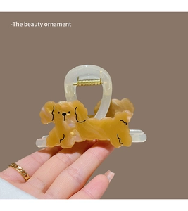 Detail of a brown marble acrylic puppy hair claw clip with a strong metal spring mechanism