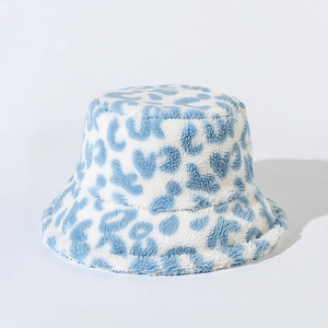 Detailed texture of blue and white leopard print faux fur winter bucket hat material