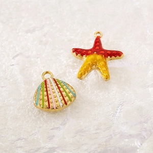 Detailed close-up of colorful enamel starfish and seashell pendants with gold plating