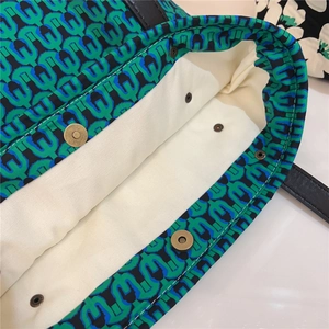 Close-up of the interior cotton lining and magnetic metal snap closure of a tote bag