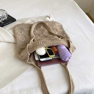 Interior view of khaki knit tote bag showing large capacity for phone and accessories
