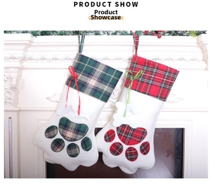 Detail of red and green plaid cat paw Christmas stockings with bone tags on fireplace