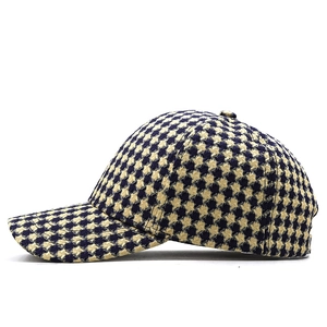 Detail of blue and yellow houndstooth knit texture on a stylish baseball cap side view