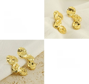 Detail of gold petal earrings with lava texture showing polished metal craftsmanship