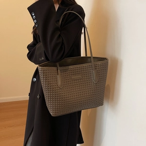 Brown woven tote bag with large capacity shown on model for a stylish daily commute look