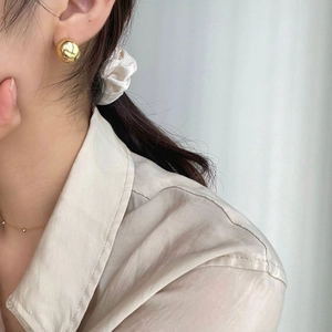 French style S925 sterling silver golden spherical stud earrings worn by a model