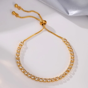 Detail of adjustable gold tennis bracelet with square-cut crystals and drawstring clasp