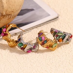 Detail of C-shaped 18K gold plated earrings with colorful crushed stones and faux pearls