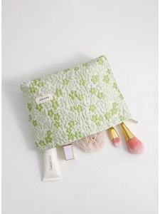 Floral jacquard travel makeup bag in green and white with zipper closure and accessories
