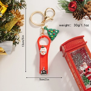 Detailed view of snowman nail clipper keychain with green Christmas tree charm