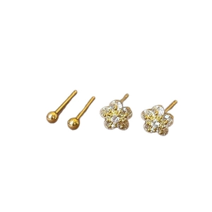 Minimalist gold flower and bead stud earring set with zircon stones on white background
