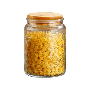 Embossed glass food storage jar with an airtight bamboo lid for kitchen organization