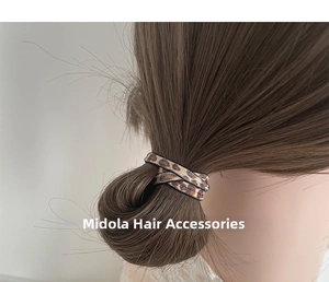 Detailed view of leopard print seamless elastic hair tie worn on a high ponytail style