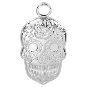 Macro shot of silver skull pendant featuring embossed rose and fine detail craftsmanship