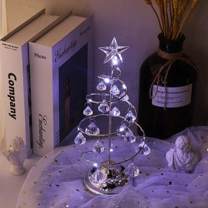 Macro shot of silver metal spiral Christmas tree with crystal pendants and LED lights