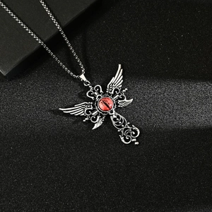 Gothic winged cross necklace featuring a central red cat-eye stone and silver metal finish