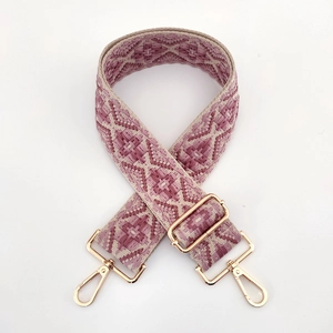 Close-up of pink geometric jacquard strap with light gold metal swivel hooks and buckle